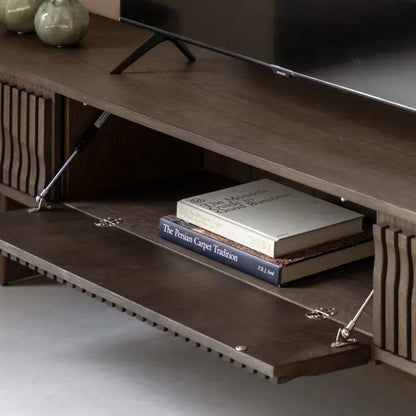 The Gallery Direct Onda Media Unit features 2 side drawers and a middle cabinet door with cable tidy access, and a slatted wave design to the cabinet doors