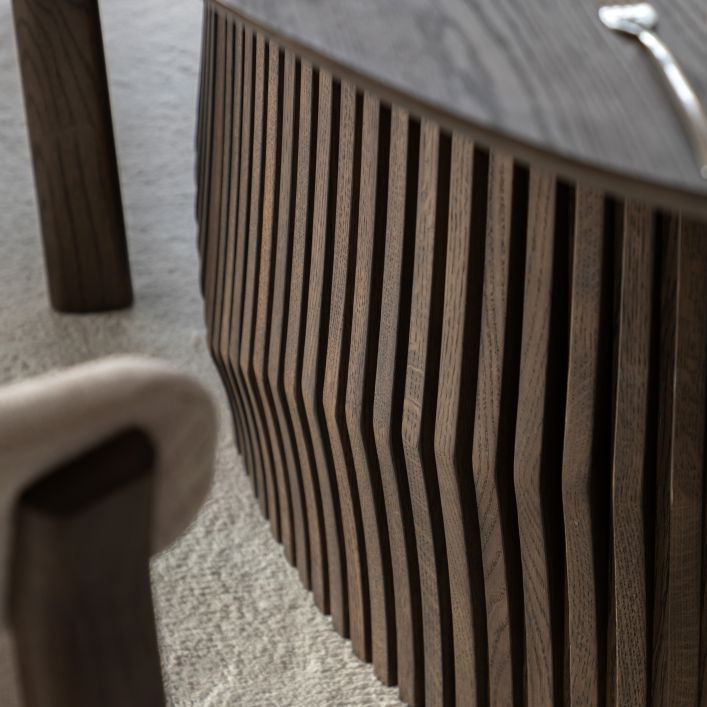 Gallery Direct Onda Oval Extending Dining Table is a modern Italian inspired design featuring a slatted wave pattern to the base and a sleek wooden table top in a rich charcoal brown finish