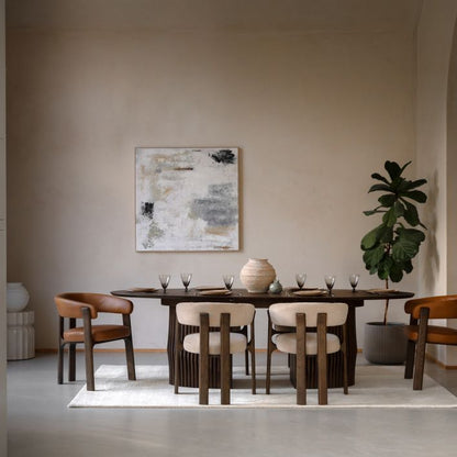 The Gallery Direct Onda Oval Extending Dining Table constructed from solid oak wood and veneers in a charcoal brown finish, is an Italian inspired table with slatted wave design chunky base and a sleek table top that can seat up to 6.