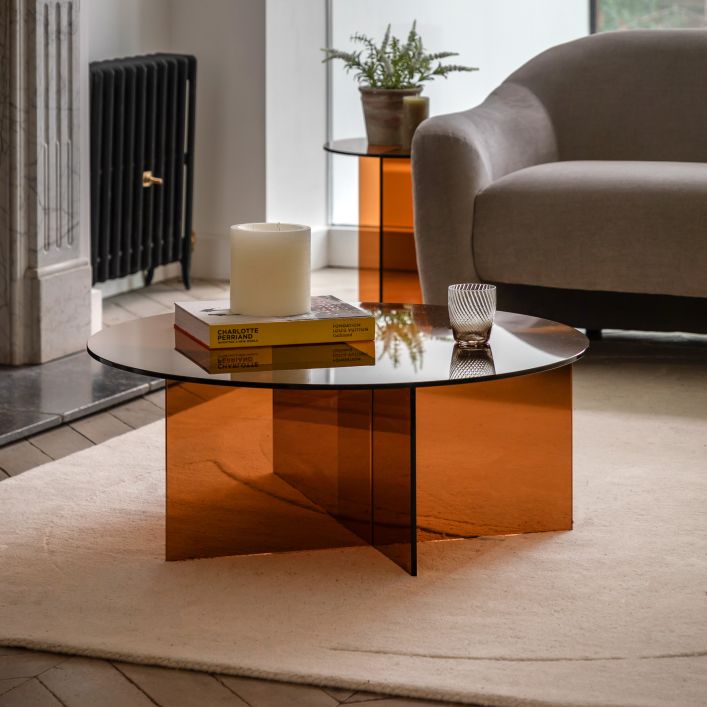 The Gallery Direct Parioli Round Glass Coffee Table is a 70s inspired round table in a Bronze coloured toughened glass with cross legged base