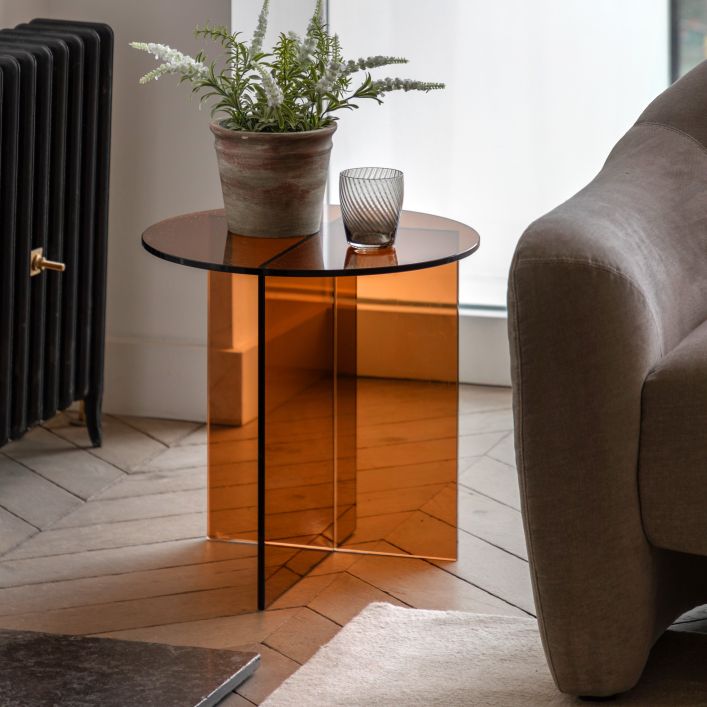The Gallery Direct Parioli Glass Side Table has a round toughened glass table top and matching base with cross legged design in a clear Bronze colour