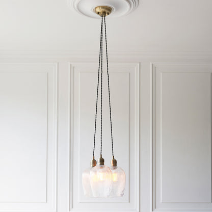 Gallery Direct Polaris 3 Ribbed Cluster Pend Light Antique Brass, styled in a room setting