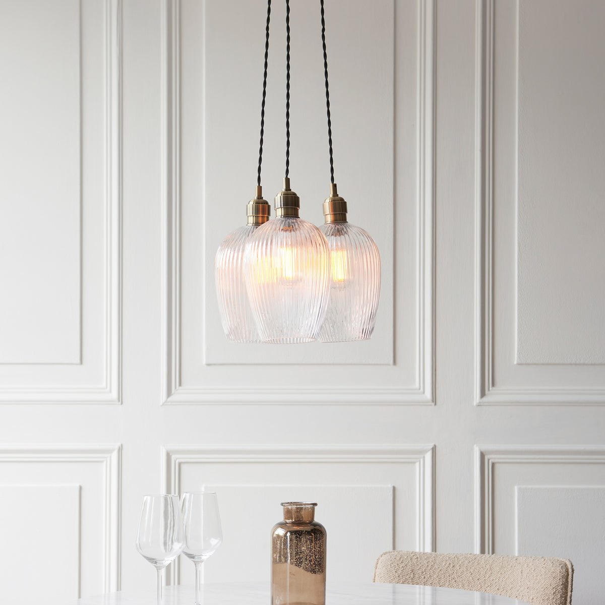 Gallery Direct Polaris 3 Ribbed Cluster Pend Light Antique Brass, styled in a room setting
