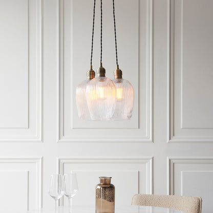 Gallery Direct Polaris 3 Ribbed Cluster Pend Light Antique Brass, styled in a room setting