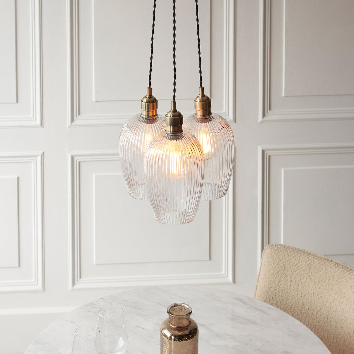 Gallery Direct Polaris 3 Ribbed Cluster Pend Light Antique Brass, styled in a room setting