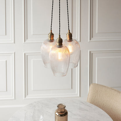 Gallery Direct Polaris 3 Ribbed Cluster Pend Light Antique Brass, styled in a room setting