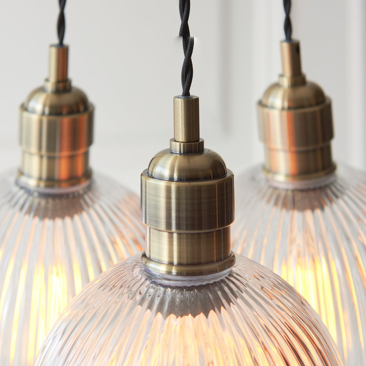 Gallery Direct Polaris 3 Ribbed Cluster Pend Light Antique Brass, close-up of the finish and design