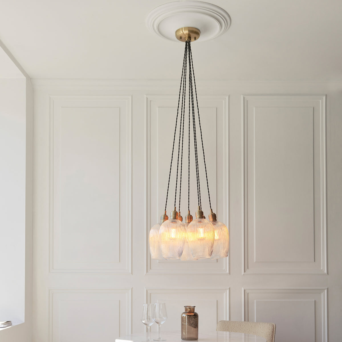 Gallery Direct Polaris 7 Ribbed Cluster Pend Light Antique Brass, styled in a room setting