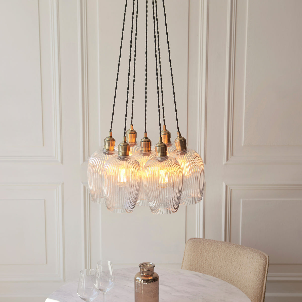 Gallery Direct Polaris 7 Ribbed Cluster Pend Light Antique Brass, styled in a room setting