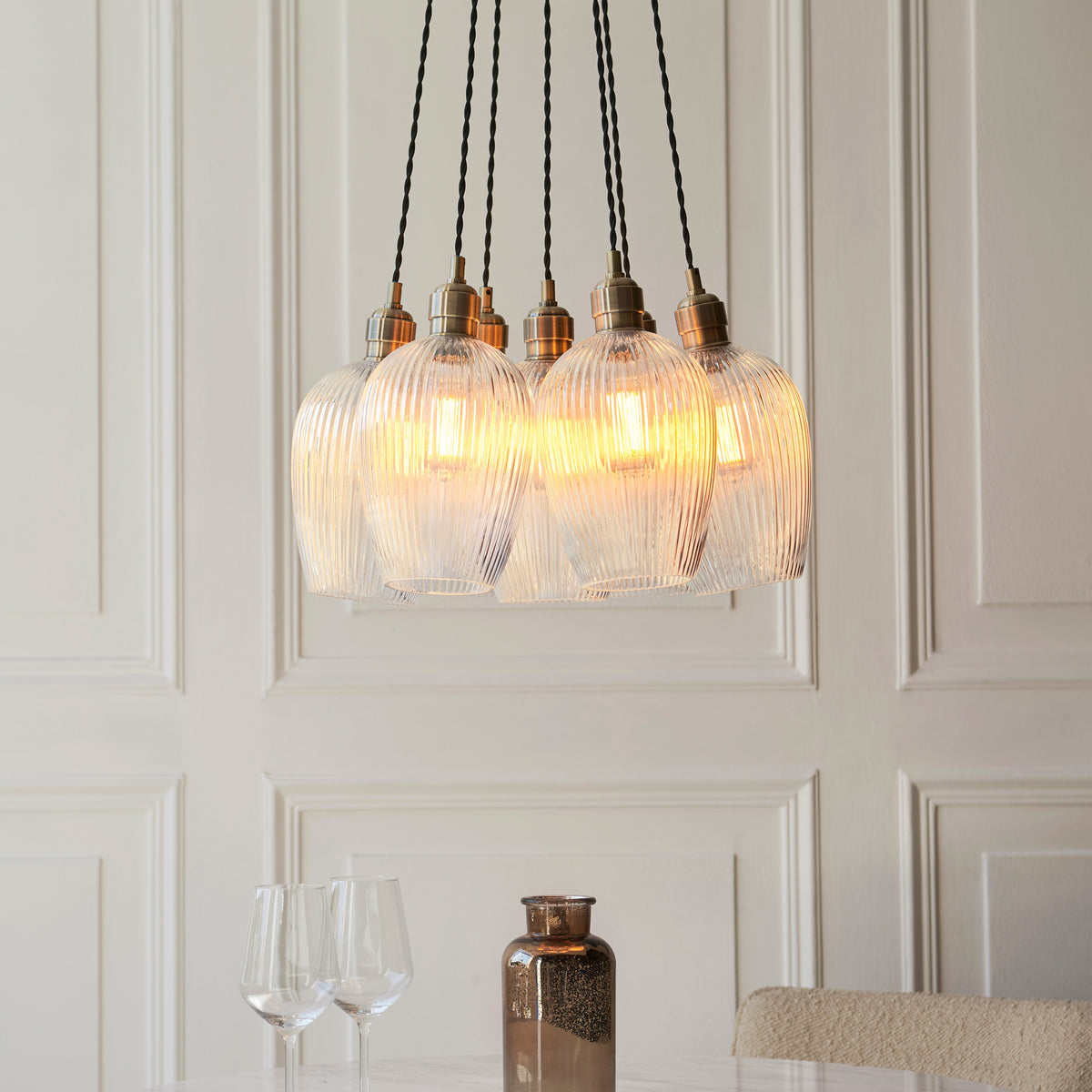 Gallery Direct Polaris 7 Ribbed Cluster Pend Light Antique Brass, styled in a room setting