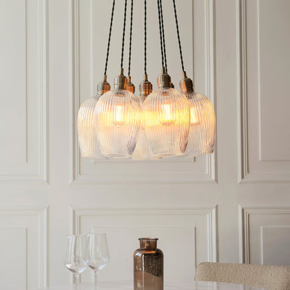 Gallery Direct Polaris 7 Ribbed Cluster Pend Light Antique Brass, styled in a room setting
