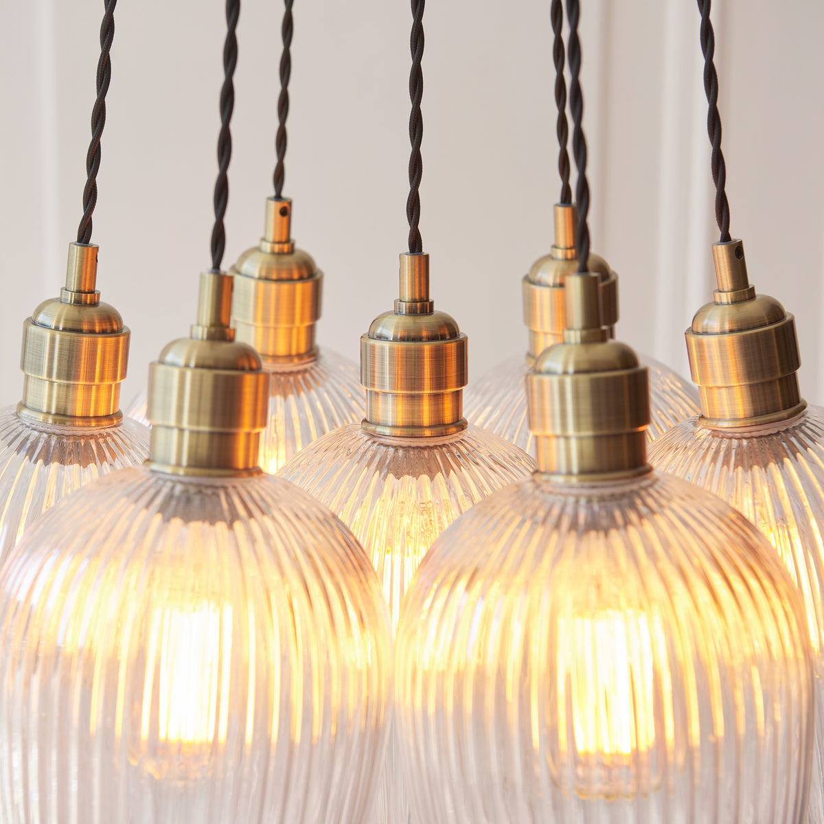 Gallery Direct Polaris 7 Ribbed Cluster Pend Light Antique Brass, close-up of the finish and design