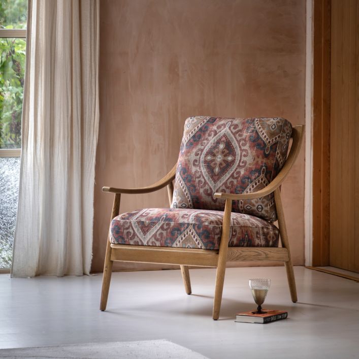 The Gallery Direct Reliant Armchair is a mix of mid-century style and contemporary comfort, with a stunning ash wood frame and seat cushions upholstered in Zari Jacquard fabric