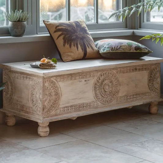Gallery Direct Satara Storage Table Bench crafted from mango wood with a white wash finish and intricate carved detailing to the front and sides and a hinged top lip with generous storage compartment