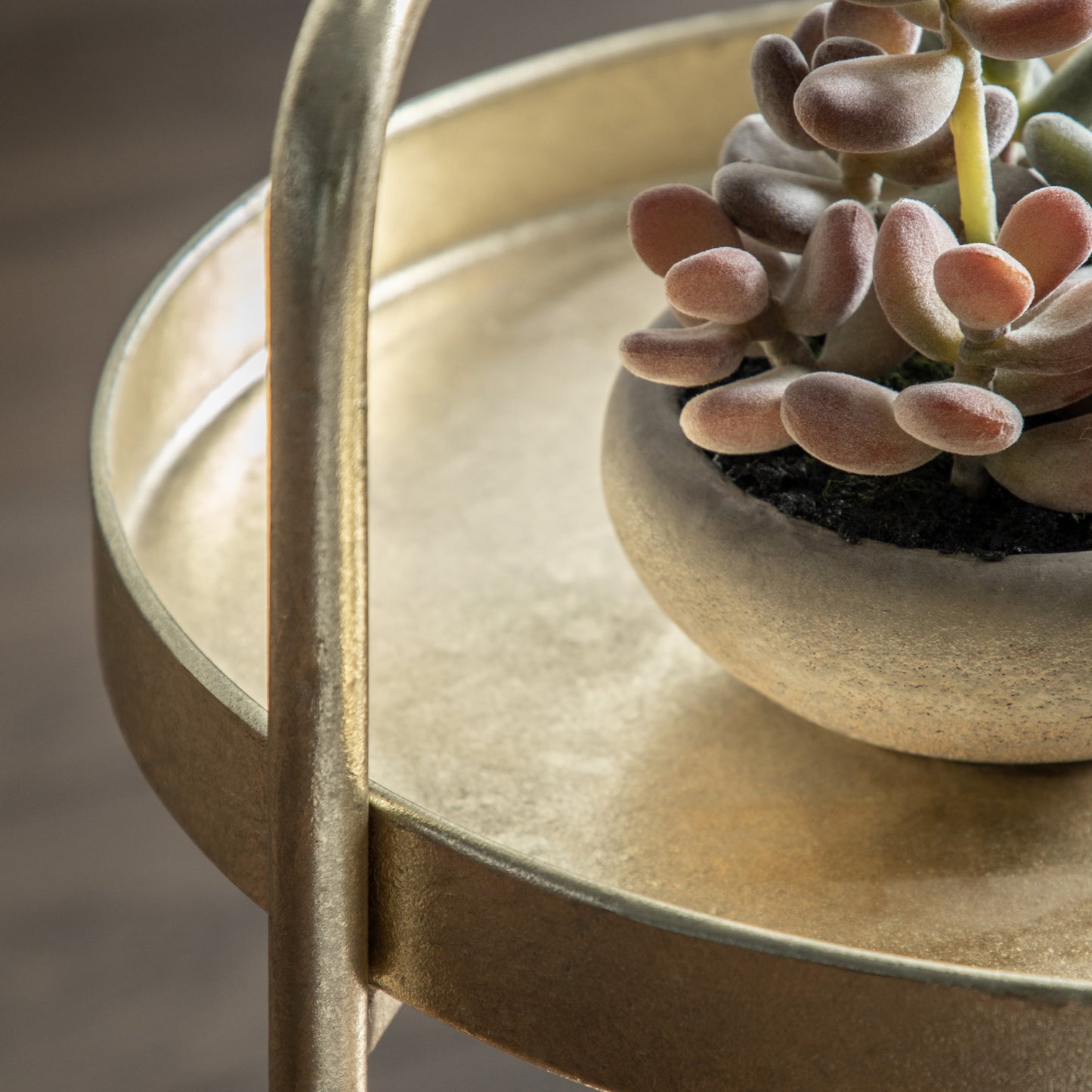 Gallery Direct Sennen Side Table crafted from metalwork with a hand applied ragged Gold leaf finish, a tray style table top and a lower shelf