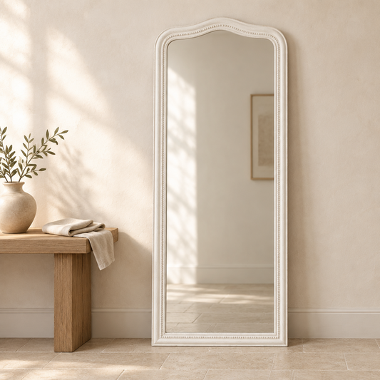 Gallery Direct Shoreline Arch Leaner Mirror White positioned beside an oak console in a neutral interior