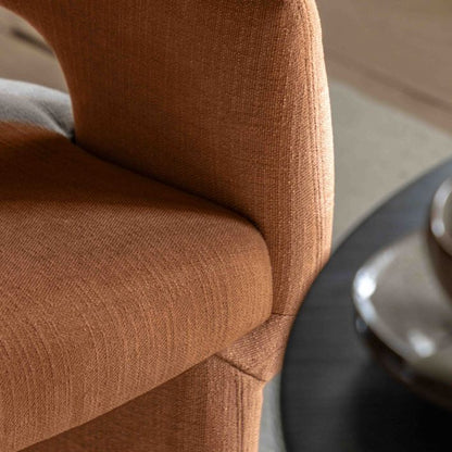 Gallery Direct Sloane Dining Chair is a modern, contemporary chair that is fully upholstered in a warm rust colour
