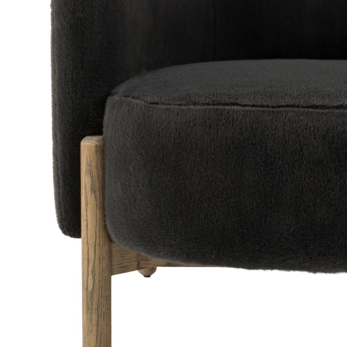 Gallery Direct Tindon Armchair upholstered in an Alaska Graphite coloured faux fur, with contrasting light wooden legs