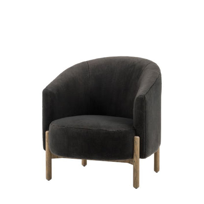 The Gallery Direct Tindon Armchair is upholstered in a soft plush Alaska Graphite coloured faux fur, with contrasting light wood base and legs