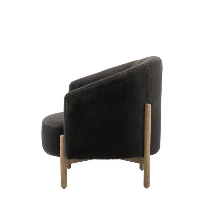 Gallery Direct Tindon Armchair in Alaska Graphite colour faux fur, with light wooden legs and base