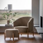 The Gallery Direct Tindon Footstool in Alaska Khaki colour, is upholstered in a soft plush, faux fur material, with contrasting light wooden legs