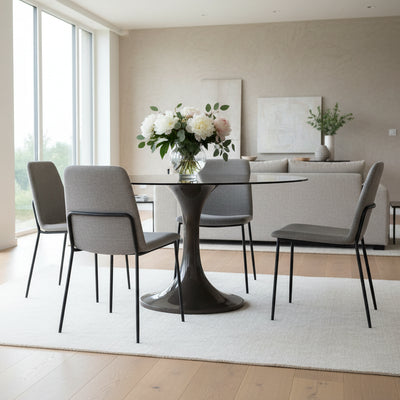 The Gallery Direct Tivoli Round Dining Table is constructed from glass reinforced concrete (GRC) for the fluted base and a subtly tinted toughened glass table top, in a rich brown colour palette 