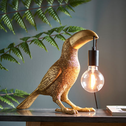 Gallery Direct Toucan Table Lamp Gold, styled in a room setting