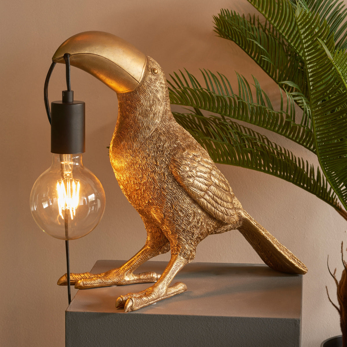 Gallery Direct Toucan Table Lamp Gold, styled in a room setting