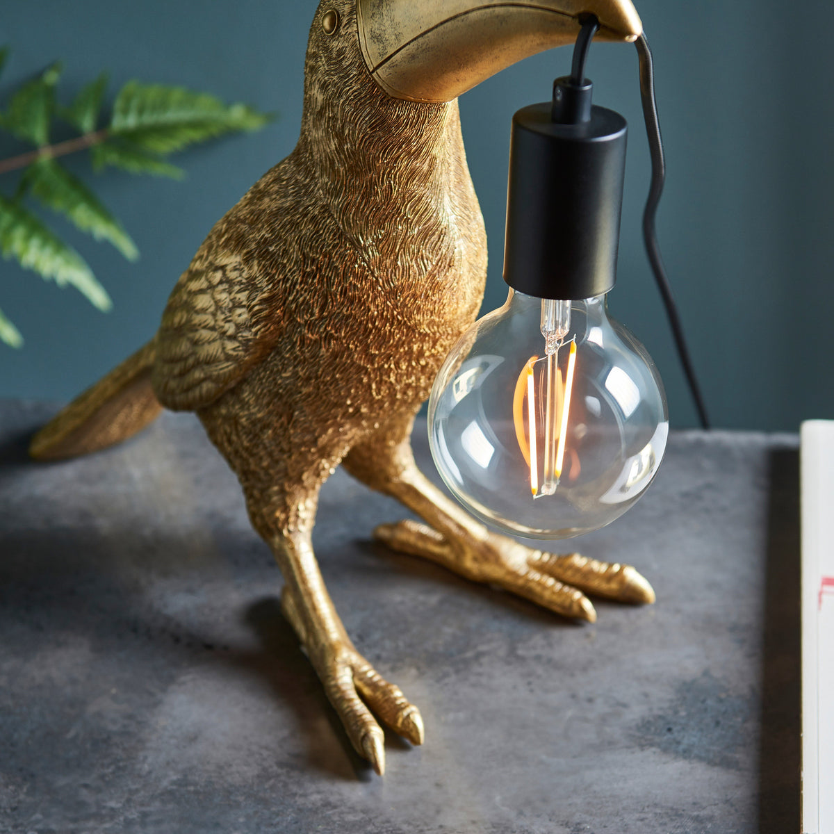 Gallery Direct Toucan Table Lamp Gold, styled in a room setting