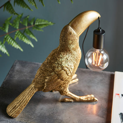 Gallery Direct Toucan Table Lamp Gold, styled in a room setting