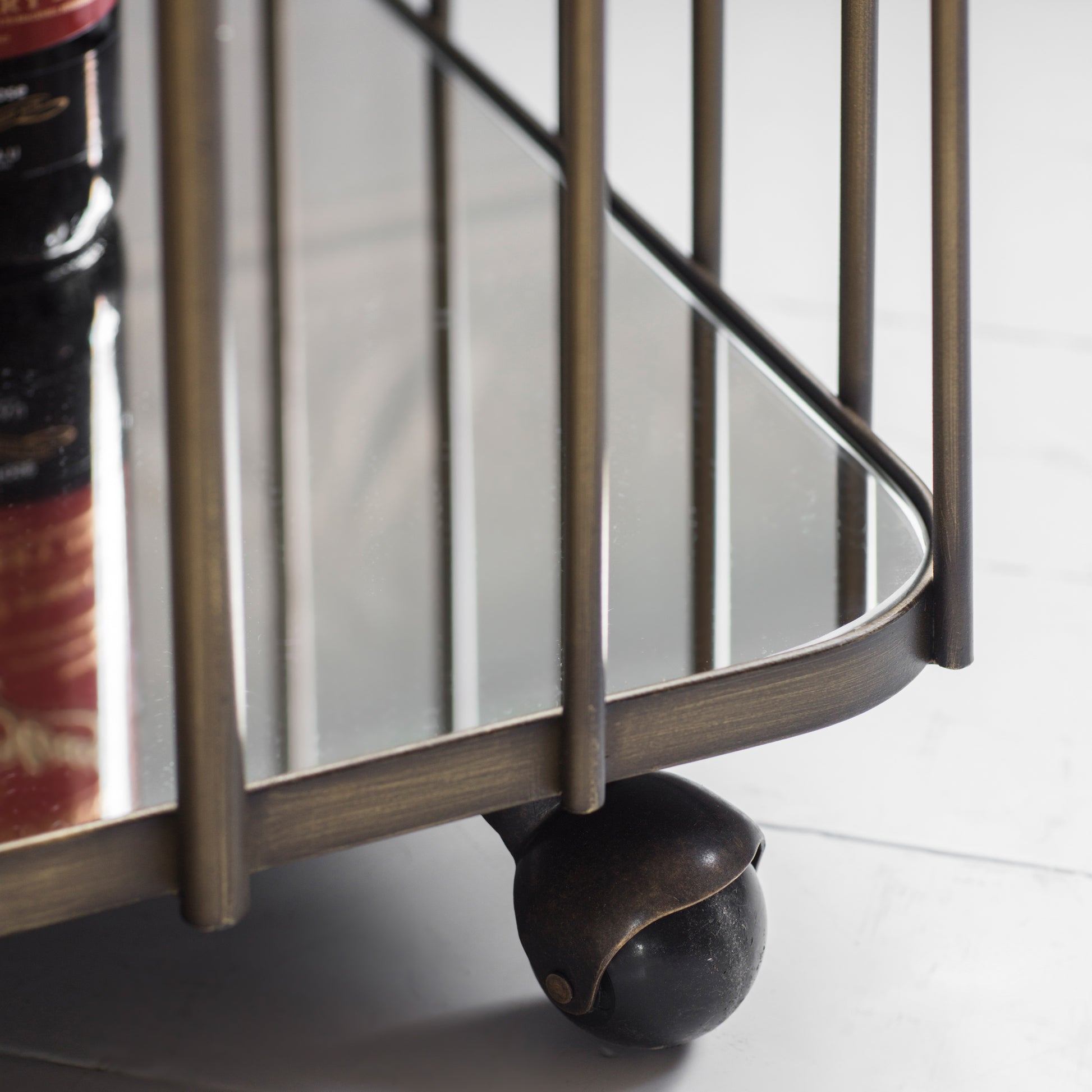 Gallery Direct Verna Drinks Trolley in Bronze metal with a toughened glass frame and rolling castors