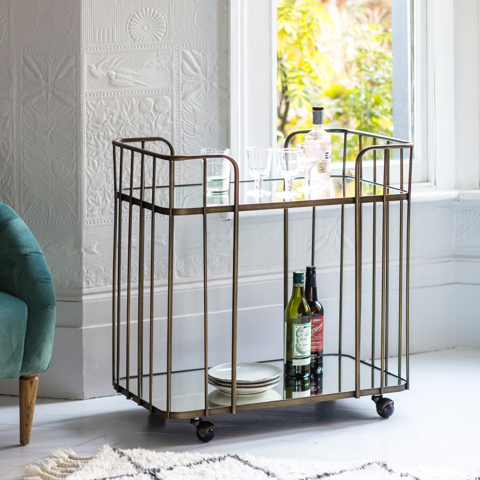 Gallery Direct Verna Drinks Trolley features a Bronze metal frame with toughened glass shelves and smooth rolling castors 