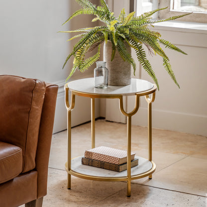 Gallery Direct Weston Side Table White Marble beside a brown sofa with a plant on top
