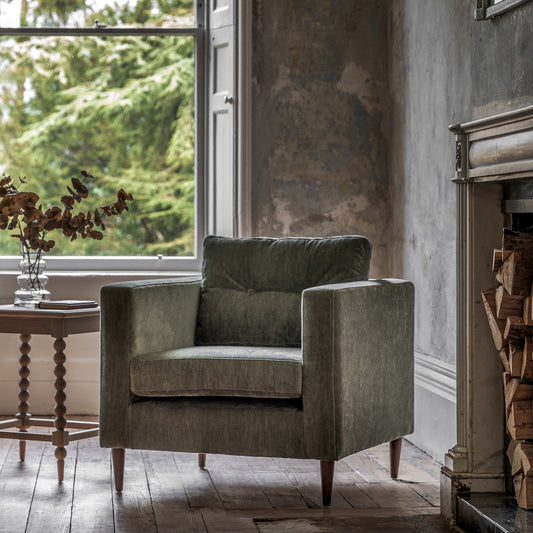 Gallery Direct Whitwell Armchair in Forest green, with a distinctive squared frame, button tufted back cushion and tapered wooden legs