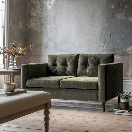 Gallery Direct Whitwell 2 Seater Sofa Upholstered in Forest Green, with a structured frame, button tufted cushions and tapered wooden legs