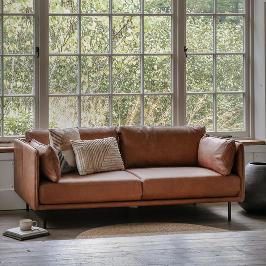 Gallery Direct Wigmore Brown Leather 3 Seater Sofa features a slim frame with stitch seam detailing, side cushions, and black metal legs