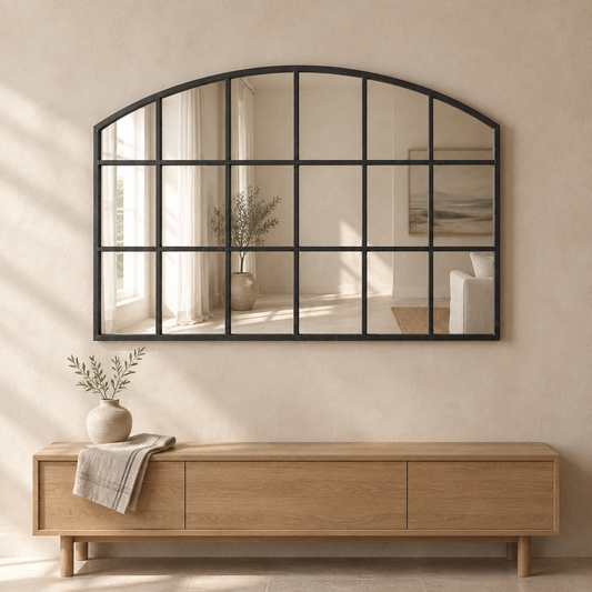 Gallery Direct Wingham Arch Mirror Black above an oak console in a neutral interior