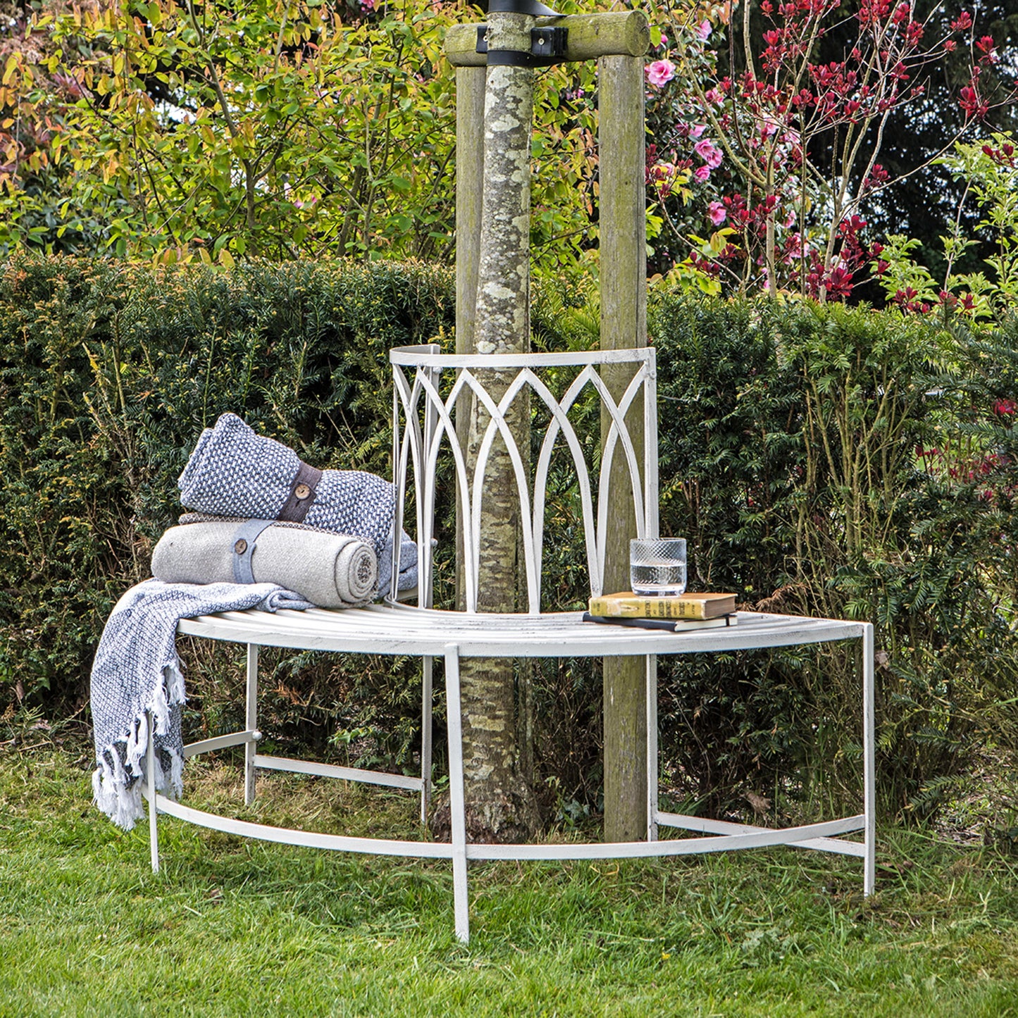 Gallery Garden Alberoni Outdoor Tree Bench Seat crafted from iron and painted in a Distressed White