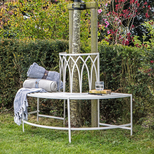 Gallery Garden Alberoni Outdoor Tree Bench Seat crafted from iron and painted in a Distressed White