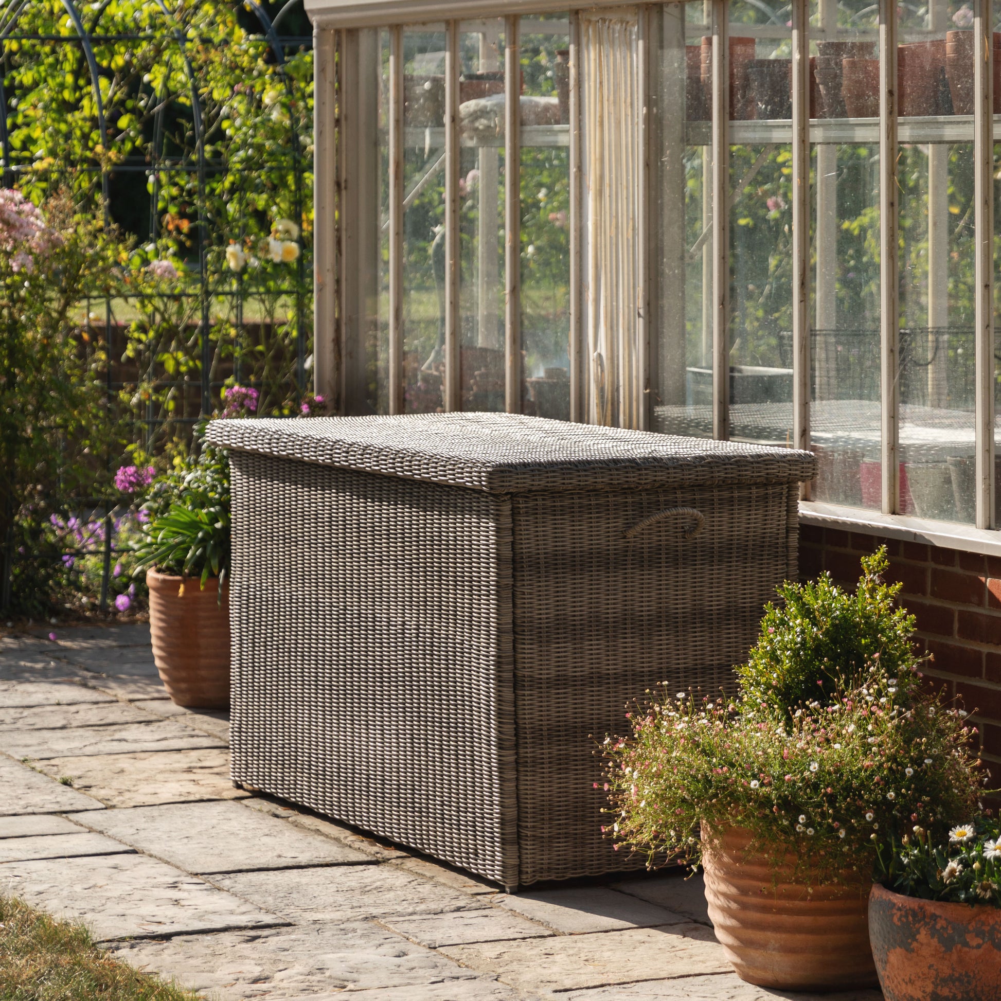 Gallery Garden Alton Outdoor Storage Box constructed from a shower proof plastic wicker in Salt Spray Grey colour, with lift up hinged lid and side handles