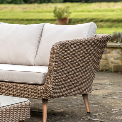 Gallery Garden Avena Corner Lounge Set features a poly-rattan wicker style sofa frame with acacia wood legs and cream padded seat cushions, plus a glass top square coffee table 