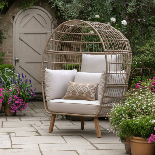 Gallery Garden Avena Egg Chair has a tall rounded frame with open wickerwork and natural toned plush cushioning