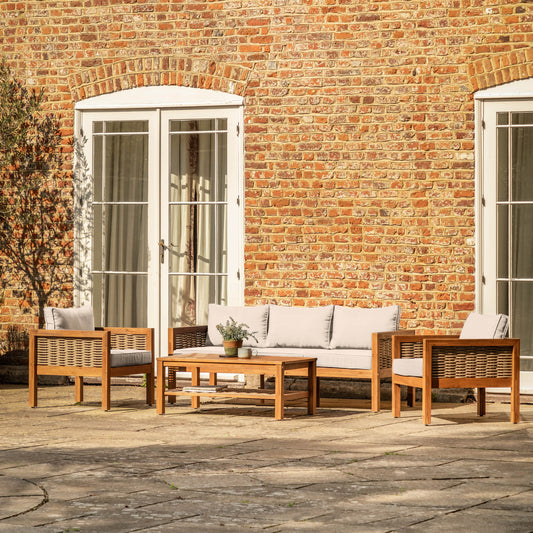 Gallery Garden Belize 4 Piece Lounge Set features a 3 seater sofa, 2 armchairs and a coffee table, crafted from acacia wood with woven wicker detailing and sumptuous natural coloured cushions