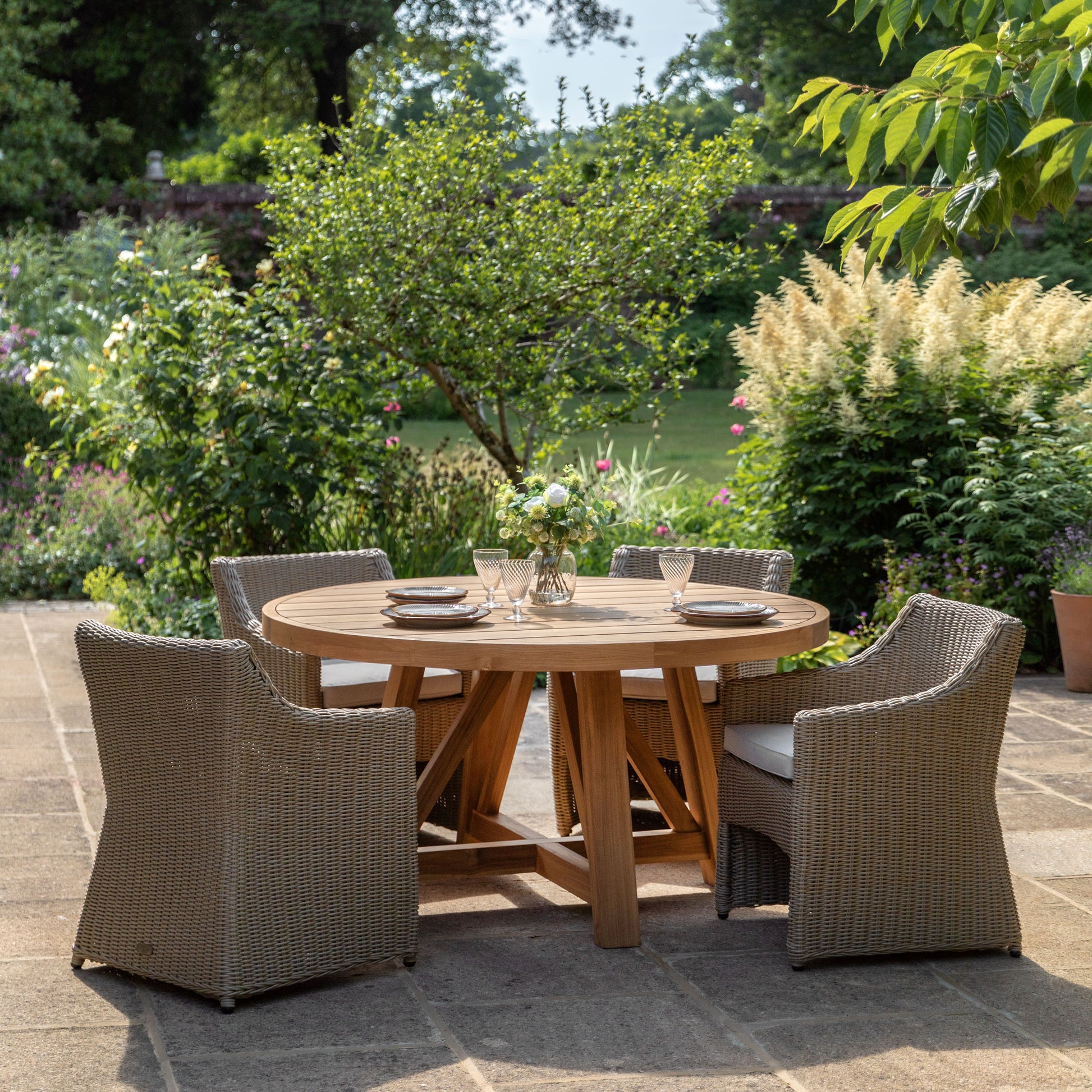 Gallery Garden Chatsworth Round Dining Table crafted from premium teak wood with grooved table top and a trestle style base. Can seat 4 people comfortably