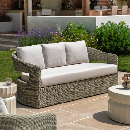Gallery Garden Hvar 3 Seater Sofa features a grey toned wicker frame with cut-out curved back and natural coloured, padded seat cushions