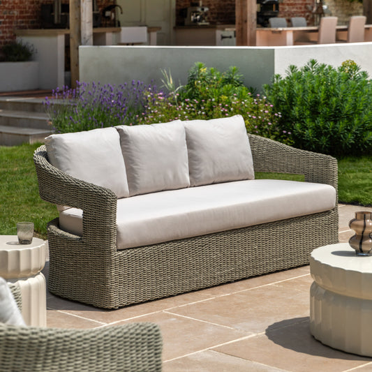 Gallery Garden Hvar 3 Seater Sofa features a grey toned wicker frame with cut-out curved back and natural coloured, padded seat cushions