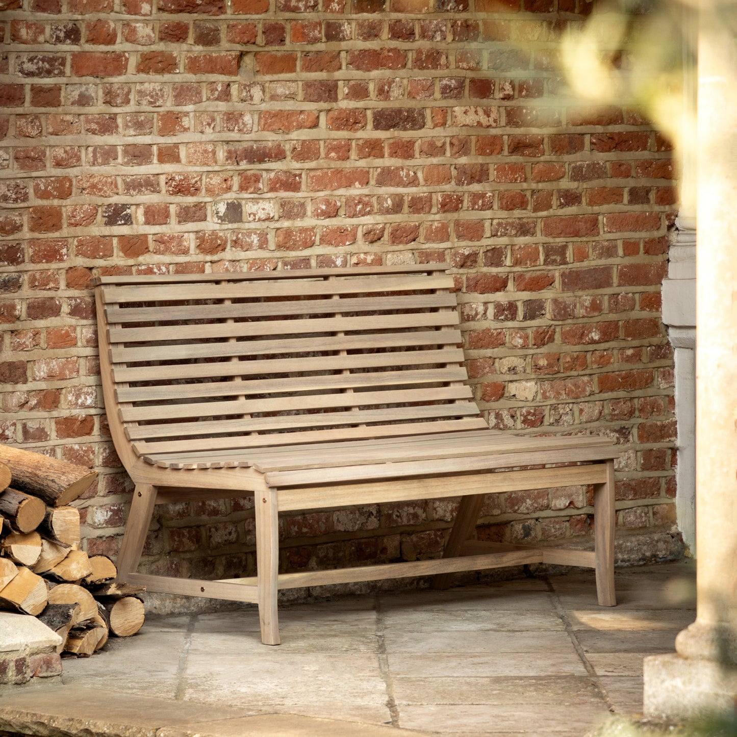Gallery Garden Kalamata 2 Seater Outdoor Bench, crafted from natural acacia wood with a gently curved, slatted wood design