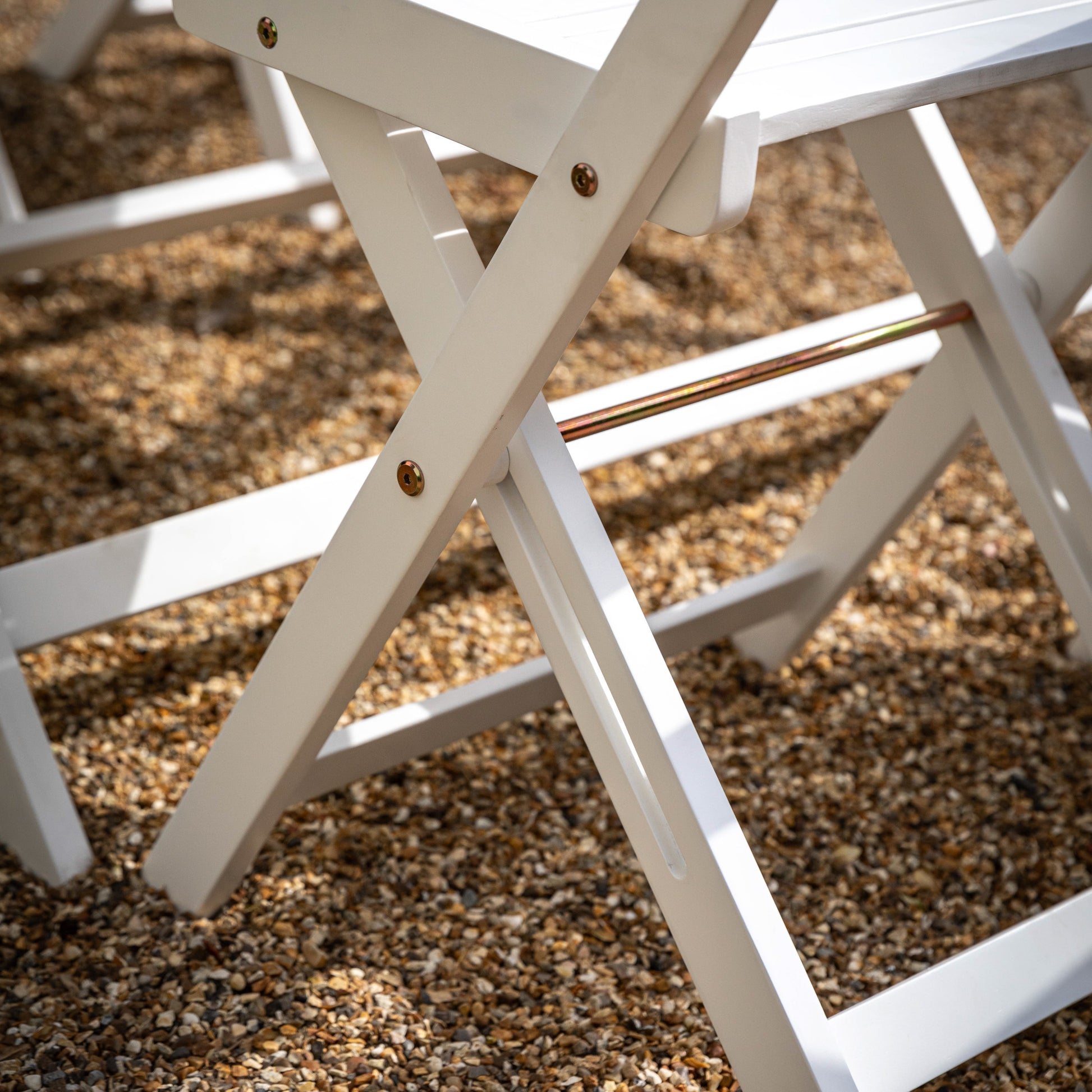 Gallery Garden Lindos Foldaway Dining Set has 4 folding chairs and a folding table in a white painted wood 