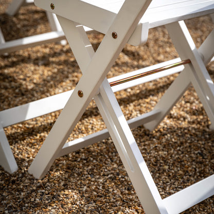 Gallery Garden Lindos Foldaway Dining Set has 4 folding chairs and a folding table in a white painted wood 
