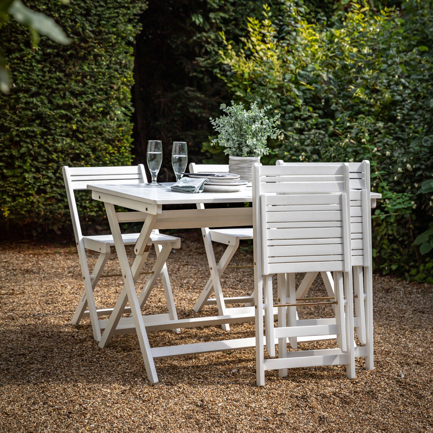 Gallery Garden Lindos Dining Set in White features a table with slatted top and 4 chairs, all can be folded for easy storage
